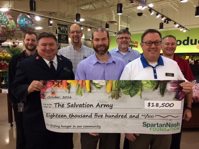 From left: Dan’s Supermarket Store Director Neil Heidt, Major John Flanagan of the Salvation Army and Store Directors Loren Olson, Kevin Bailey, Andy Dosch, Peter Bauer and Mike Mosset.