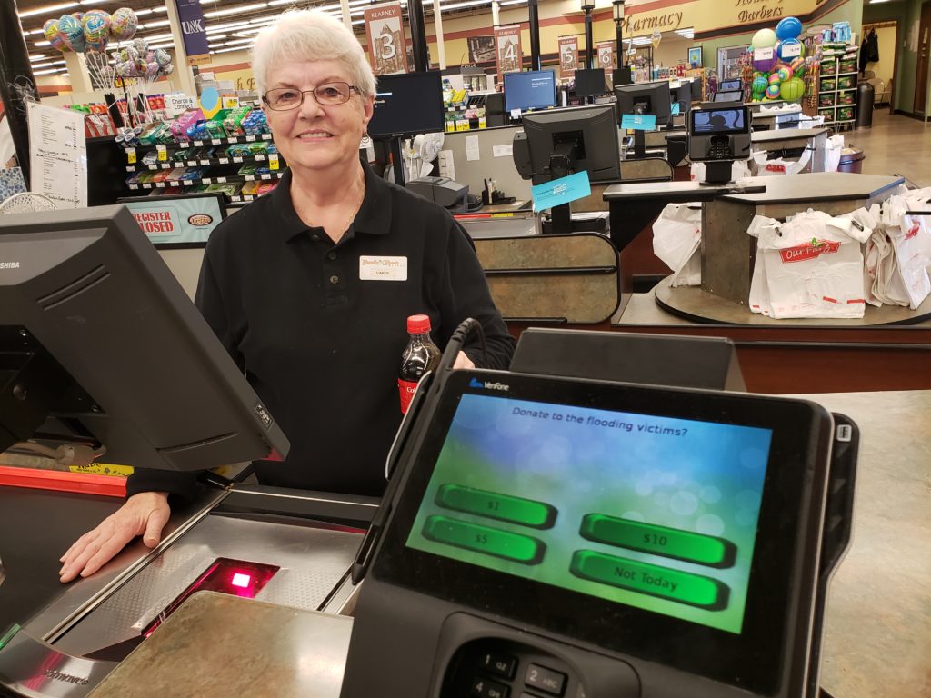 grocery store worker in checkout lane