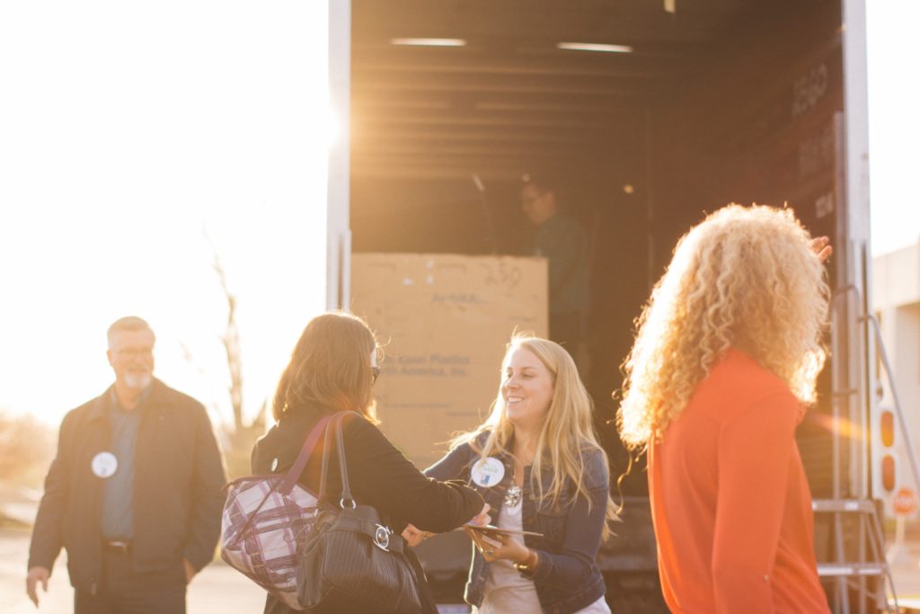 photo of people outside at the back of a box truck