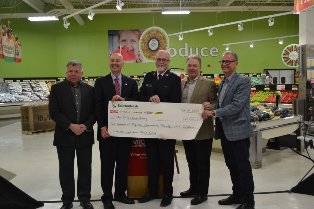 photo of a group of men holding a giant check