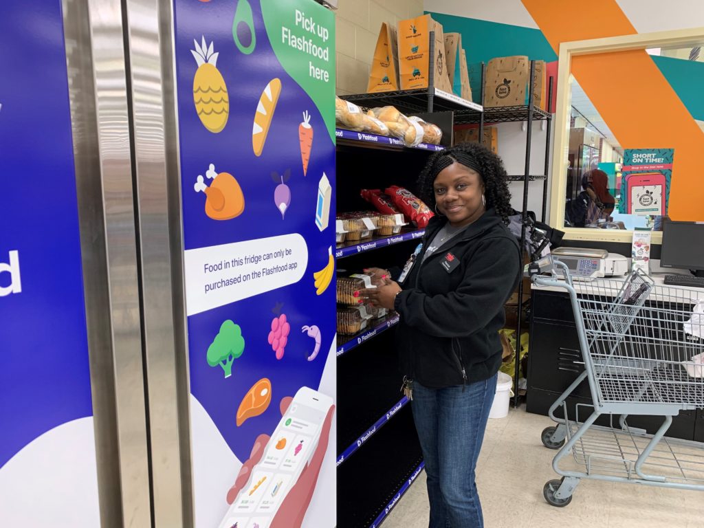 woman standing by Flashfood pickup shelf