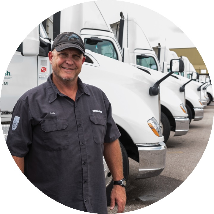 SpartanNash driver with fleet of trucks