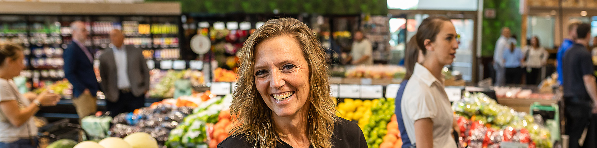 Associate smiling in retail grocery store