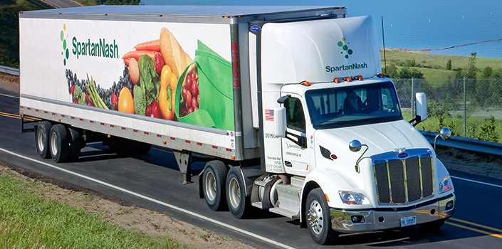 SpartanNash Associate driving truck on the road