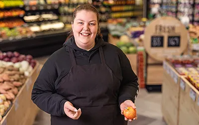 Grocery Stores Retail | woman holding food in a grocery store